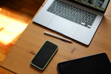 A laptop computer sitting on top of a wooden desk